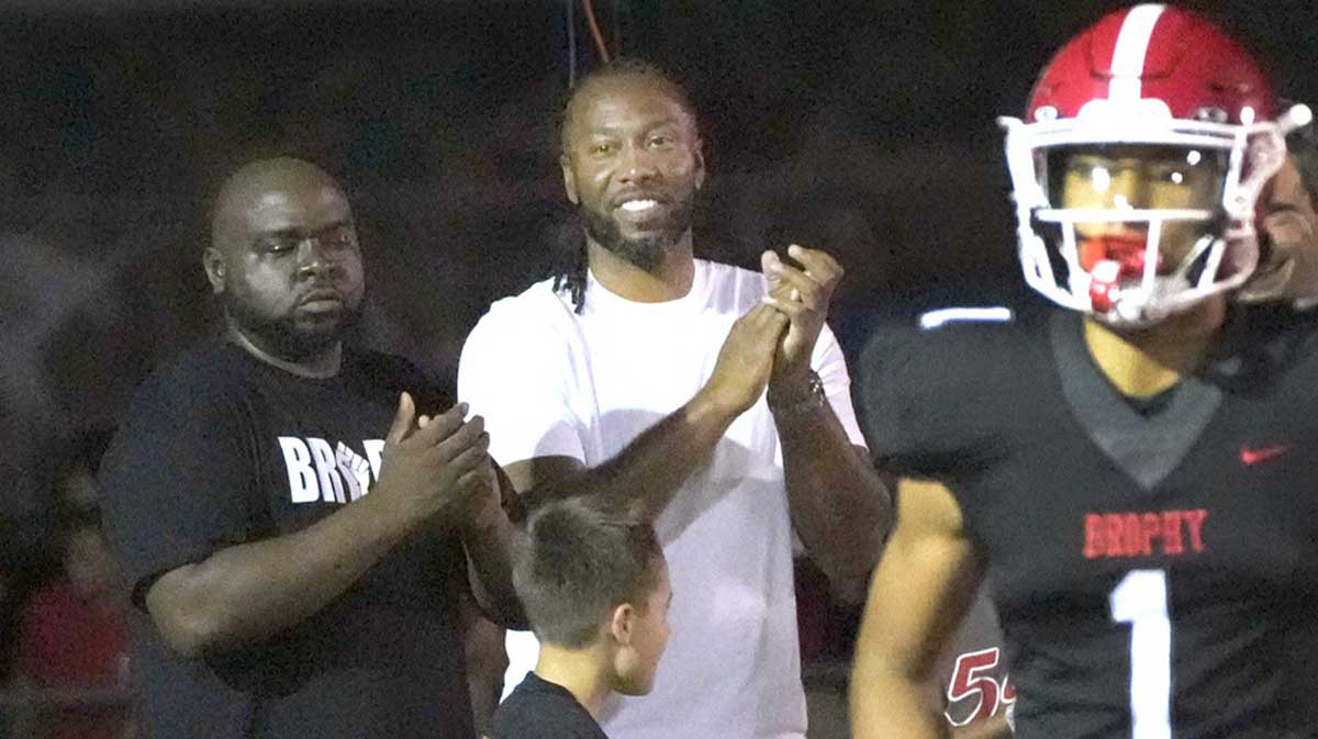 Former Arizona Cardinal wide receiver Larry Fitzgerald cheers for his son after Brophy Prep's Devin Fitzgerald (1) scores a touchdown during a game against Regis Jesuit at Central HS football field.