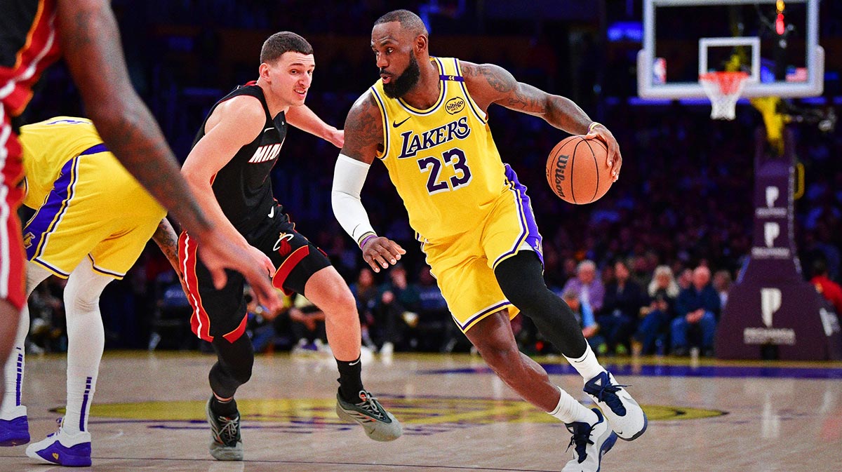 Los Angeles Lakers forward LeBron James (23) moves the ball against Miami Heat guard Tyler Herro (14) during the second half at Crypto.com Arena.