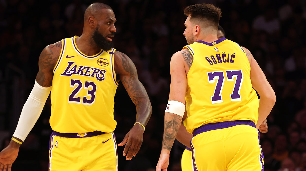 Los Angeles Lakers forward LeBron James (23) and guard Luka Doncic (77) react after a play during the first quarter against the Minnesota Timberwolves at Crypto.com Arena.