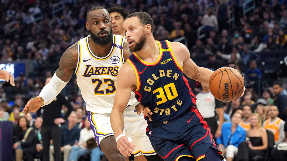 Golden State Warriors guard Stephen Curry (30) dribbles against Los Angeles Lakers forward LeBron James (23) during the third quarter at Chase Center.
