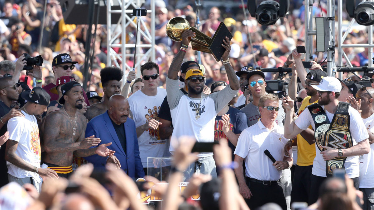 LeBron James raised the Larry O'Brien Trophy with Jim Brown by his side at the rally following the Cavaliers Championship Parade in Cleveland on Tuesday, June 21, 2016.