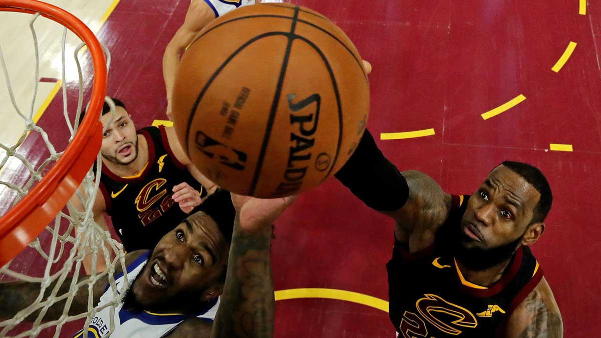 Cleveland Cavaliers forward LeBron James (23) and Golden State Warriors center Jordan Bell (2) go for a rebound in game three of the 2018 NBA Finals at Quicken Loans Arena.