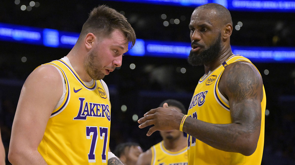 Los Angeles Lakers forward LeBron James (23) checks on guard Luka Doncic (77) after he was hit in the face against the Utah Jazz at Crypto.com Arena.