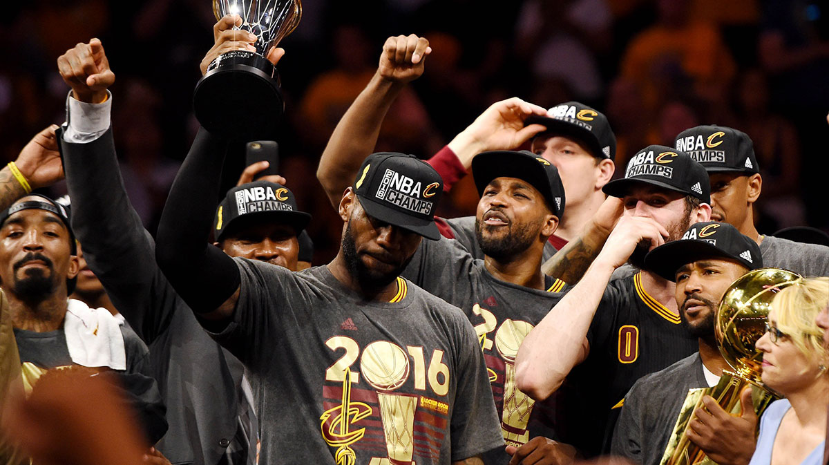 Cleveland Cavaliers forward LeBron James (23) celebrates with the Bill Russell MVP Trophy after beating the Golden State Warriors in game seven of the NBA Finals at Oracle Arena.