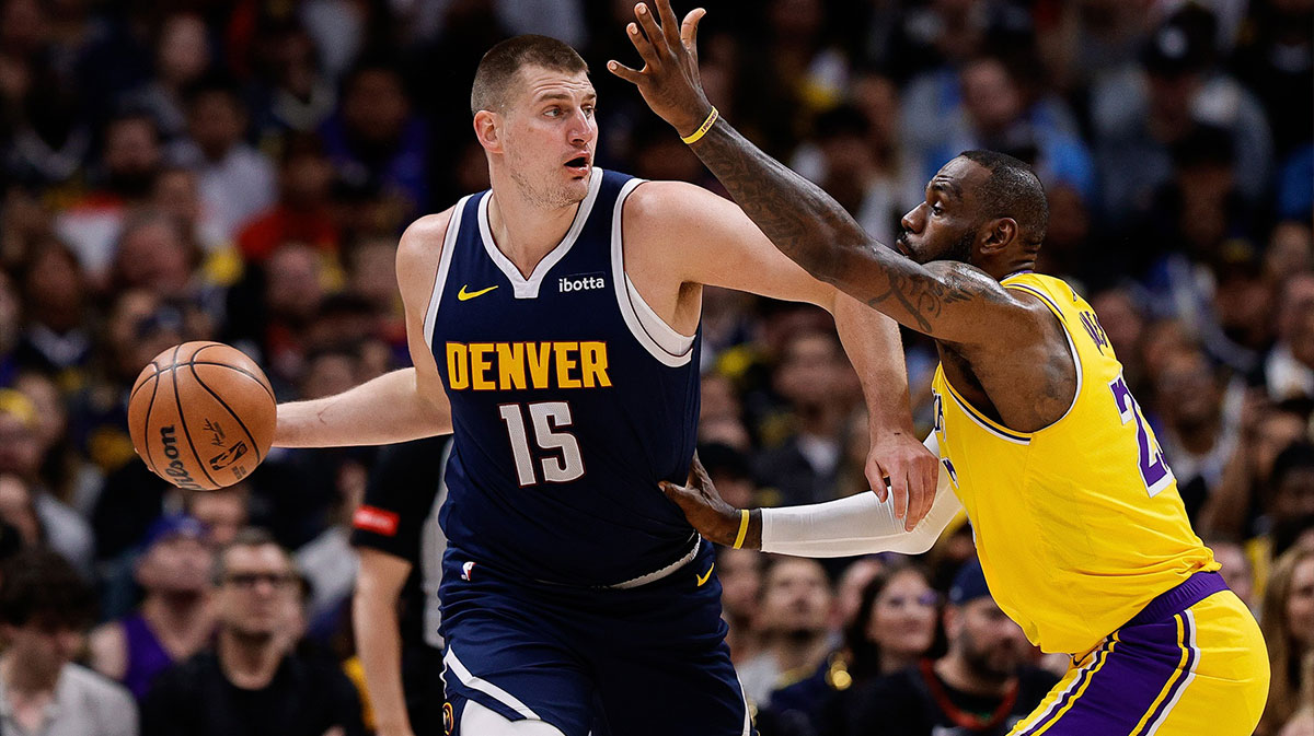 Denver Nuggets center Nikola Jokic (15) controls the ball under pressure from Los Angeles Lakers forward LeBron James (23) in the first quarter during game five of the first round for the 2024 NBA playoffs at Ball Arena.