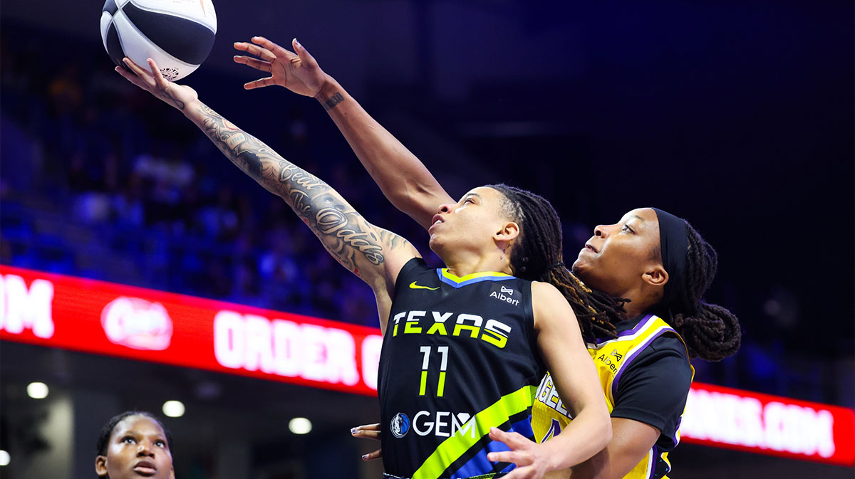 Dallas Wings guard JJ Quinerly (11) drives to the basket as Los Angeles Sparks forward Liatu King (4) defends during the second half at College Park Center.