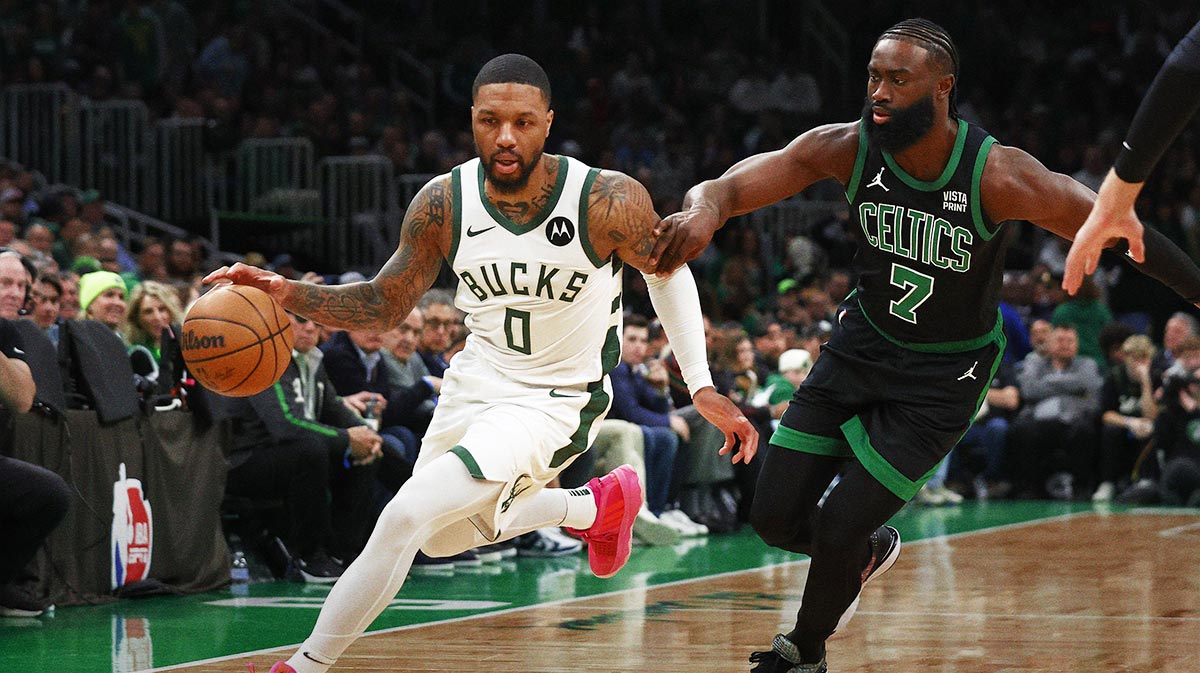 Boston Celtics guard Jaylen Brown (7) tries to hold up Milwaukee Bucks guard Damian Lillard (0) during the first quarter at TD Garden. Mandatory Credit: Winslow Townson-Imagn Images