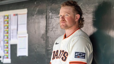 San Francisco Giants pitcher Logan Webb (62) watches from the dugout during the first inning against the Cleveland Guardians at Oracle Park