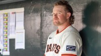 San Francisco Giants pitcher Logan Webb (62) watches from the dugout during the first inning against the Cleveland Guardians at Oracle Park