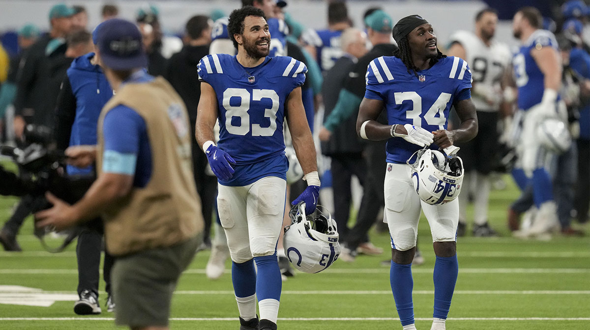 Indianapolis Colts tight end Kylen Granson (83) and Indianapolis Colts cornerback David Long Jr. (34) leave the field after defeating the Jacksonville Jaguars 26-23 in overtime at Lucas Oil Stadium.