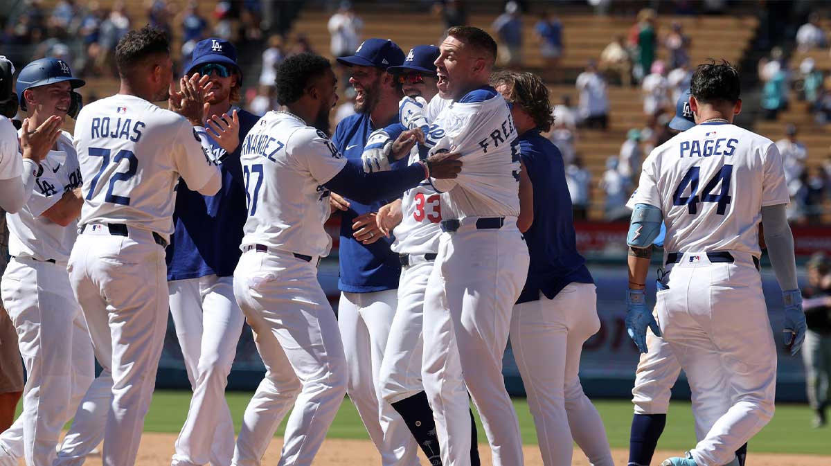 Los Angeles Dodgers first baseman Freddie Freeman (5) celebrates with teammates after hitting a game winning RBI single in the ninth inning against the Minnesota Twins at Dodger Stadium.