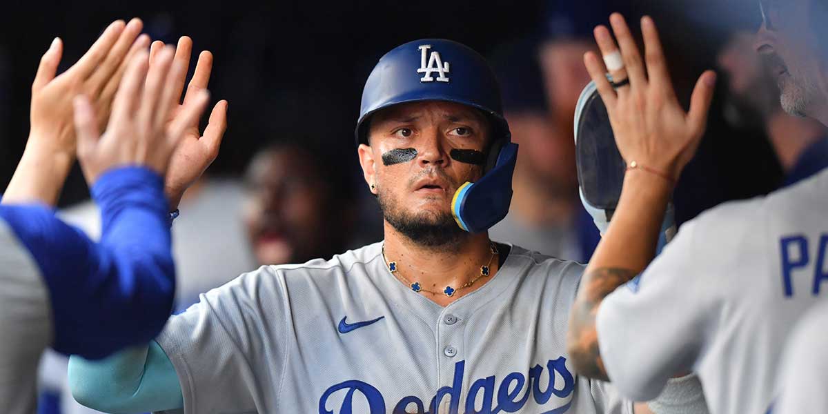 Los Angeles Dodgers third baseman Miguel Rojas (72) celebrates with teammates in the dugout after scoring during the seventh inning against the Milwaukee Brewers at American Family Field. Roberts