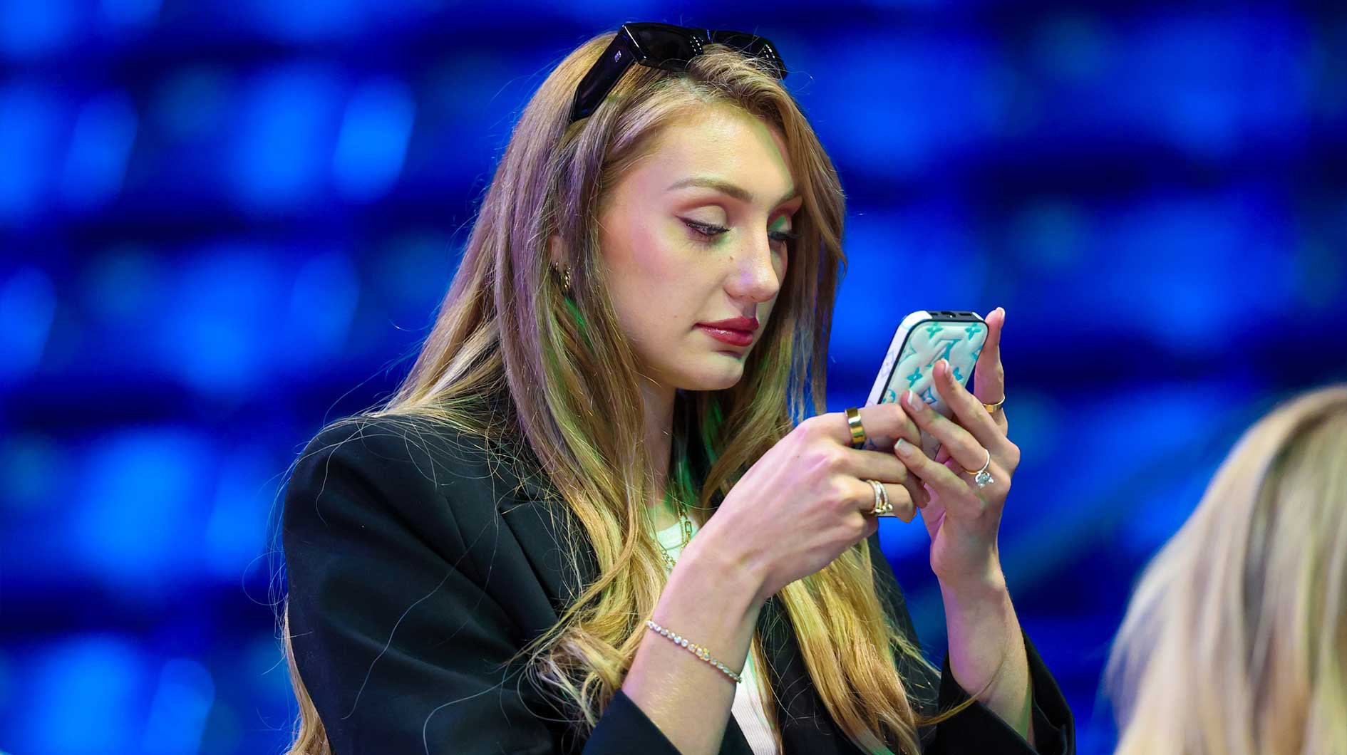 Los Angeles Sparks injured forward Cameron Brink looks at a phone before the game against the Dallas Wings at College Park Center.