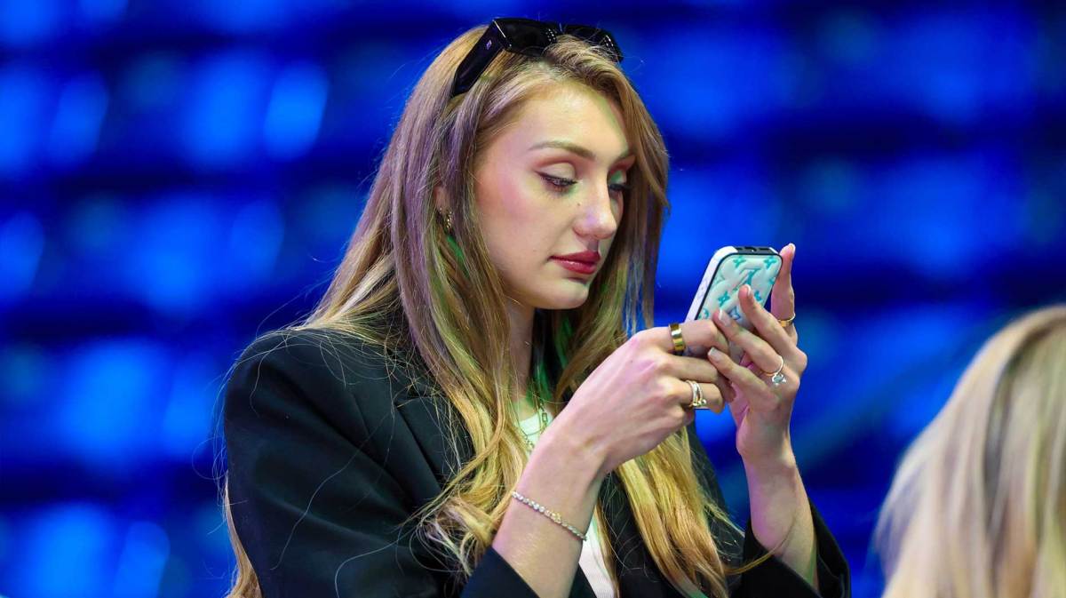 Los Angeles Sparks injured forward Cameron Brink looks at a phone before the game against the Dallas Wings at College Park Center.