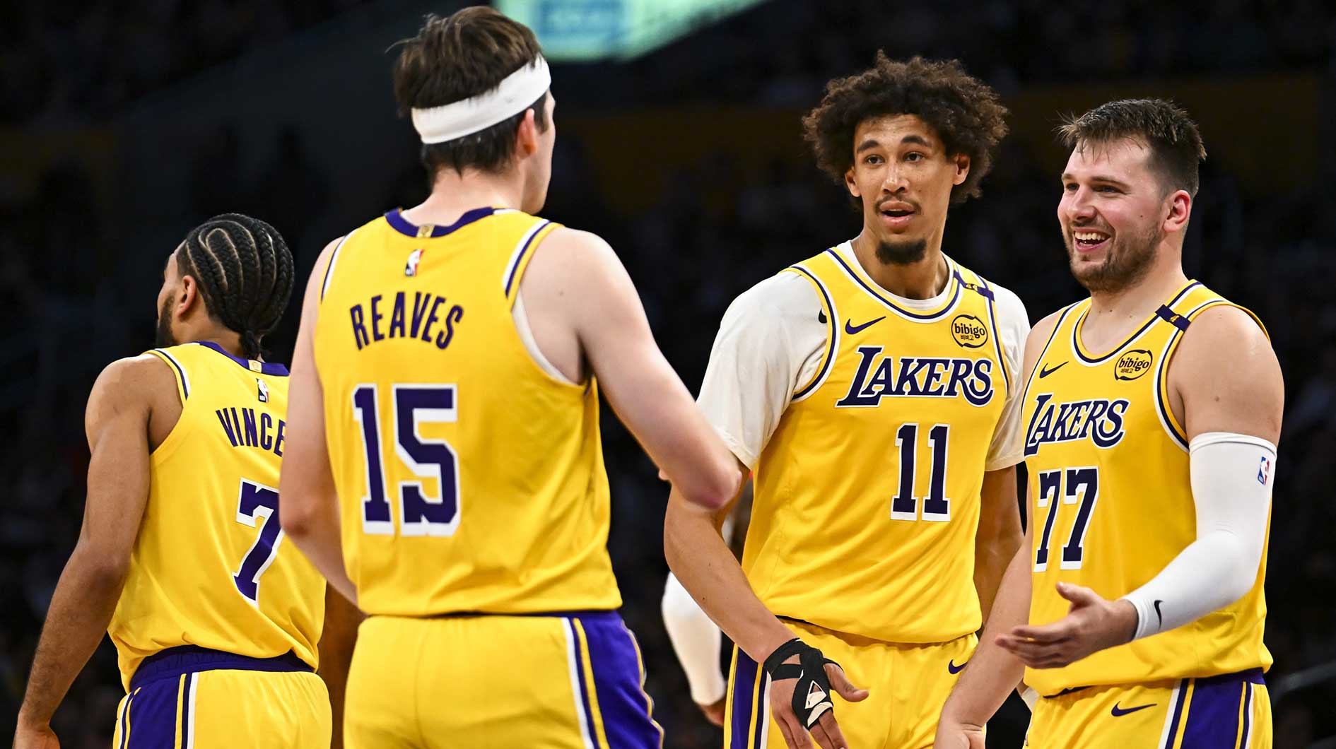 Los Angeles Lakers guard Luka Doncic (77) celebrates with center Jaxson Hayes (11), and guard Austin Reaves (15) after scoring against the Houston Rockets during the first half at Crypto.com Arena.