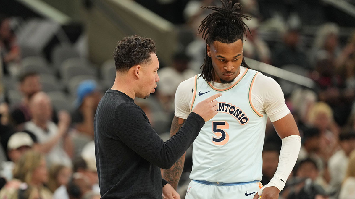 San Antonio Spurs interim coach Mitch Johnson talks with guard Stephon Castle (5) during the first half against the Toronto Raptors at Frost Bank Center.