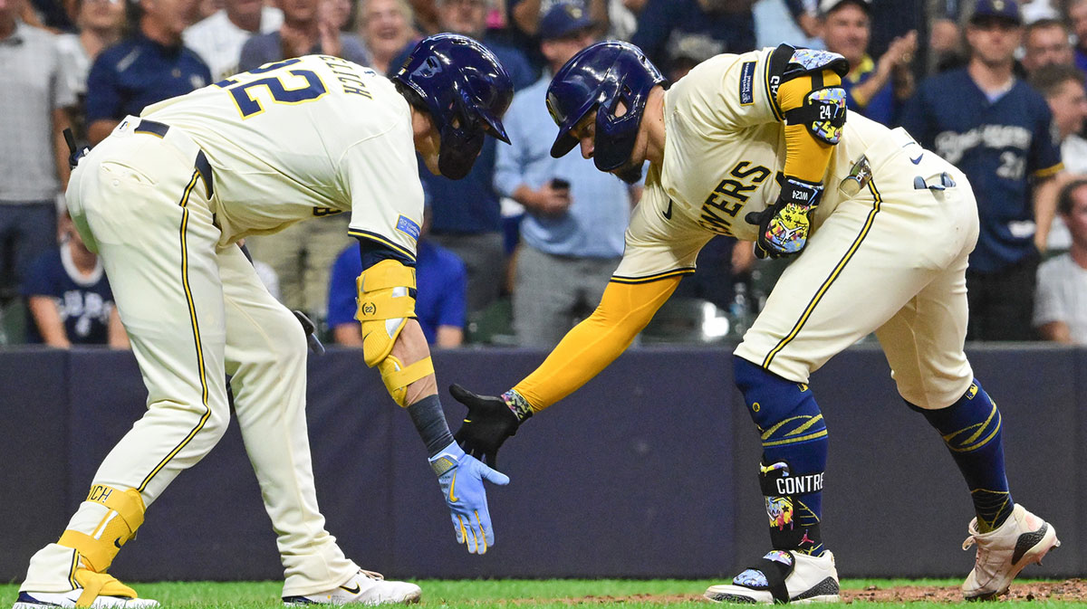 Milwaukee Brewers catcher William Contreras (24) celebrates with Milwaukee Brewers designated hitter Christian Yelich (22) after hitting a solo home run in the fourth inning at American Family Field.