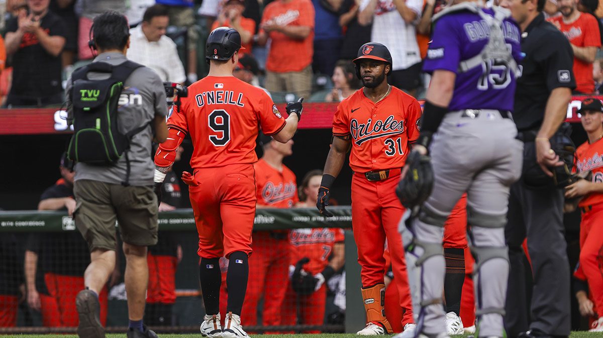 Baltimore Orioles’ designated hitter Tyler O'Neill (9) celebrates with center fielder Cedric Mullins (31) after scoring home run against Colorado Rockies in second inning at Oriole Park at Camden Yards.