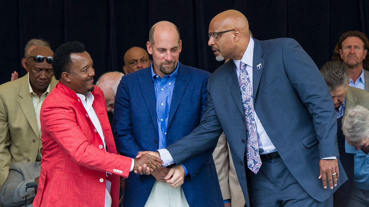 Hall of Fame inductee Pedro Martinez (left) congratulates MLBPA Executive Director Tony Clark (right) after his speech as inductee John Smoltz (center) looks on during the Awards Presentation at National Baseball Hall of Fame. MLB Crow-Armstrong