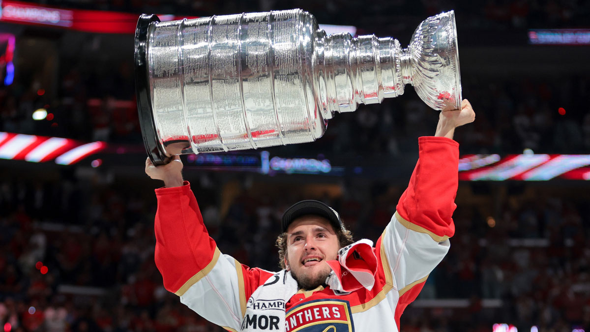 Florida Panthers right wing Mackie Samoskevich (25) hoists the Stanley Cup after winning game six of the 2025 Stanley Cup Final against the Edmonton Oilers at Amerant Bank Arena.