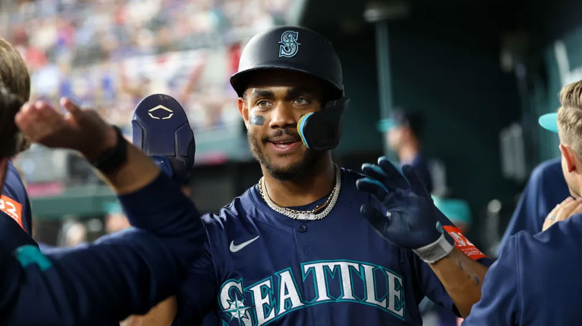 Seattle Mariners center fielder Julio Rodriguez (44) celebrates with teammates after scoring during the first inning against the Texas Rangers at Globe Life Field.