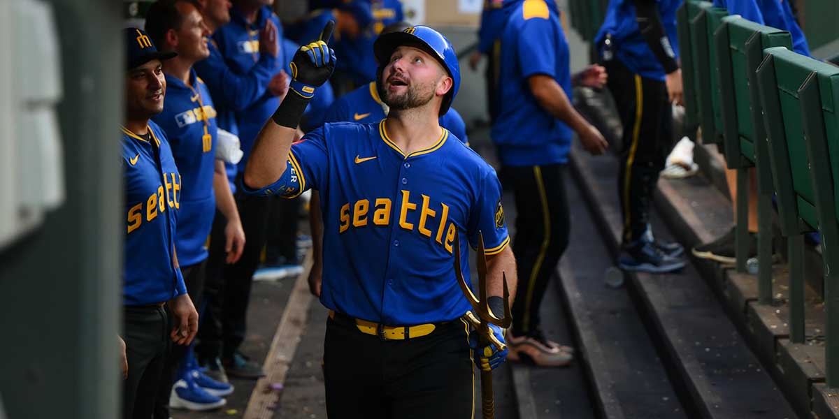 Seattle Mariners catcher Cal Raleigh (29) celebrates in the dugout after hitting a home run against the Texas Rangers during the fifth inning at T-Mobile Park.