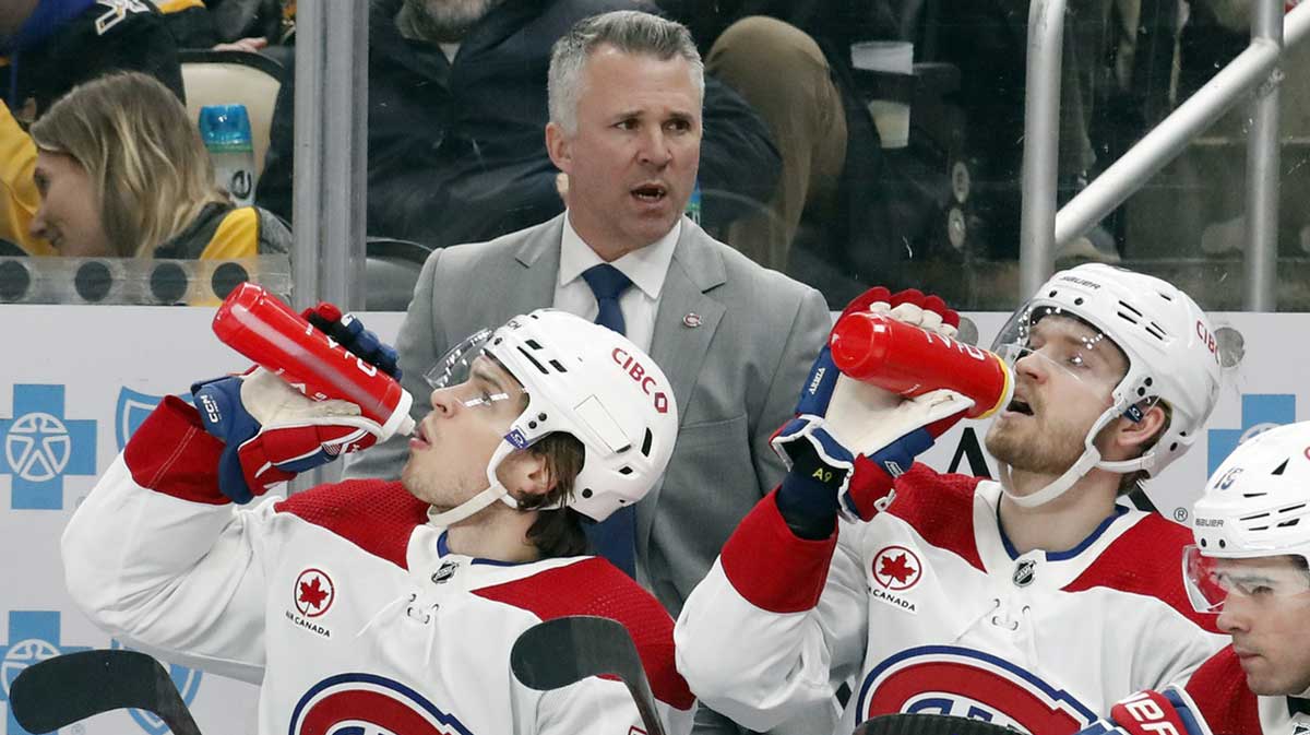 Montreal Canadiens head coach Martin St. Louis (top) looks on from the bench against the Pittsburgh Penguins during the second period at PPG Paints Arena. The Penguins won 4-1.