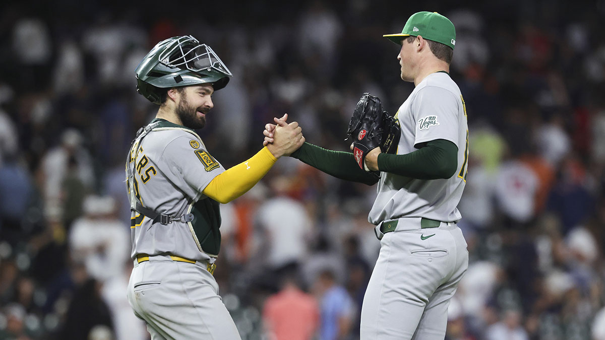 Athletics catcher Shea Langeliers (23) celebrates with relief pitcher Mason Miller (19) after the game against the Houston Astros at Daikin Park.