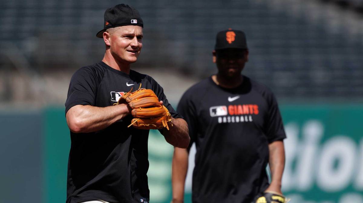 San Francisco Giants third baseman Matt Chapman (26) fields grounders before as designated hitter Rafael Devers (16) watches in the background before the game against the Miami Marlins at Oracle Park.
