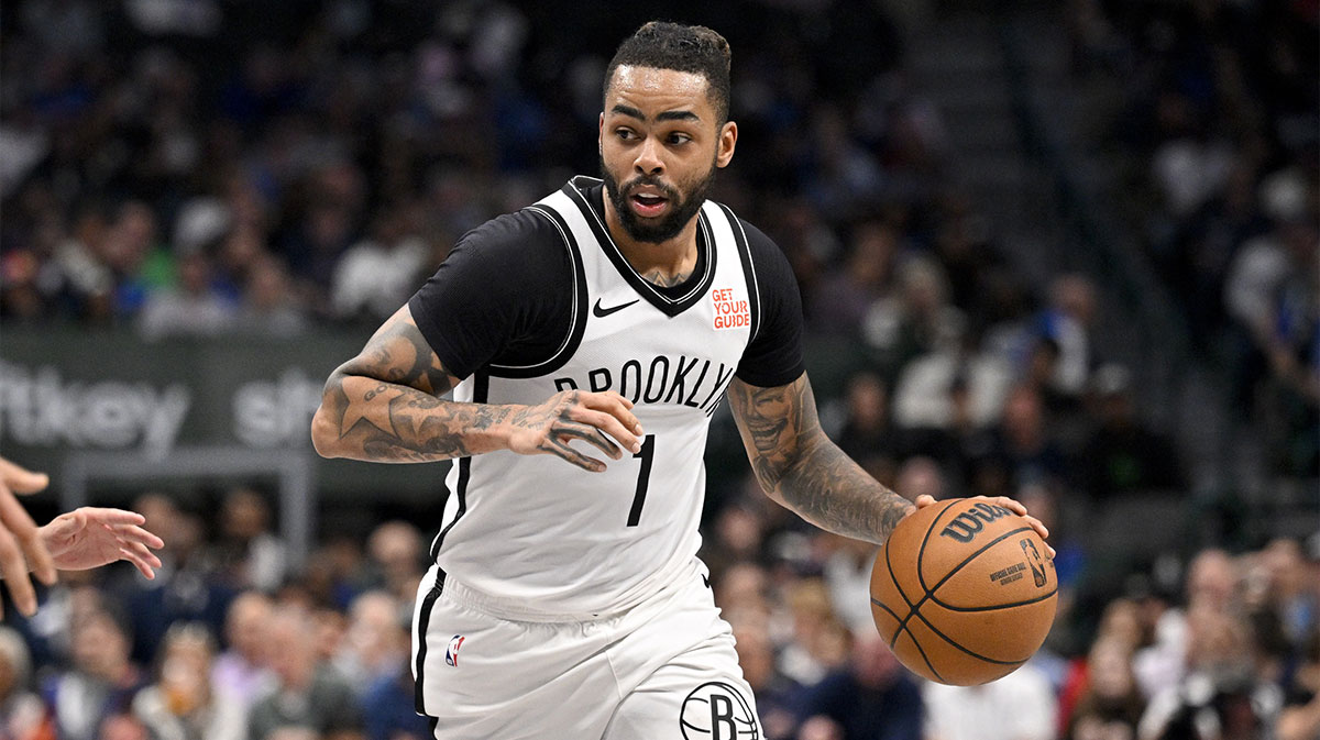 Nets guard D'Angelo Russell (1) in action during the game between the Dallas Mavericks and the Brooklyn Nets at the American Airlines Center with Chris Paul in the background