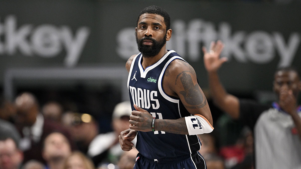Dallas Mavericks guard Kyrie Irving (11) smiles after he makes a basket against the Golden State Warriors during the second quarter at the American Airlines Center.
