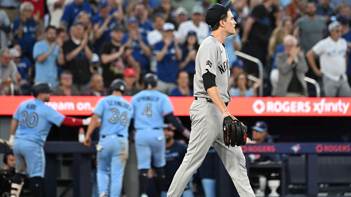 Jul 23, 2025; Toronto, Ontario, CAN; New York Yankees pitcher Max Fried (54) walks back to the mound after his throwing error allowed two Toronto Blue Jays to score in the fifth inning at Rogers Centre. 