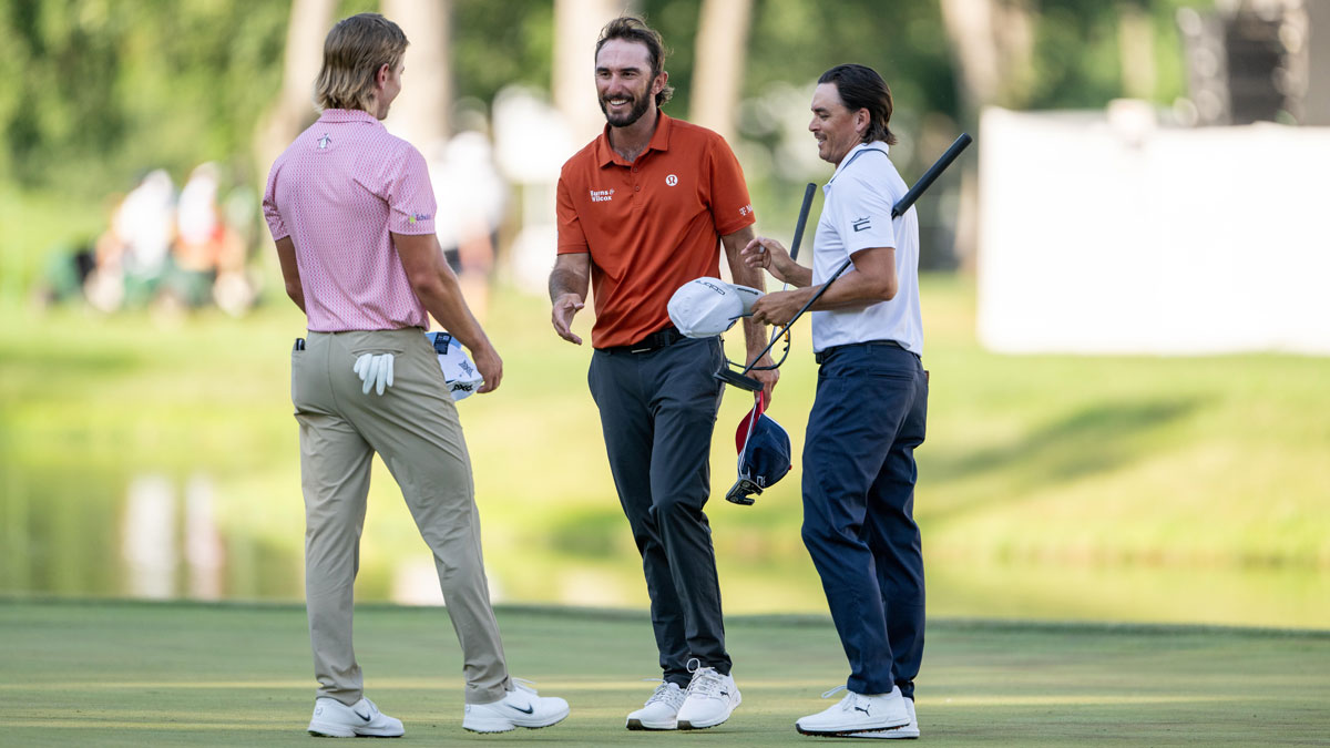 Max Homa, center, shakes hands with, Jake Knapp, left and Rickie Fowler after the second round of the John Deere Classic golf tournament.