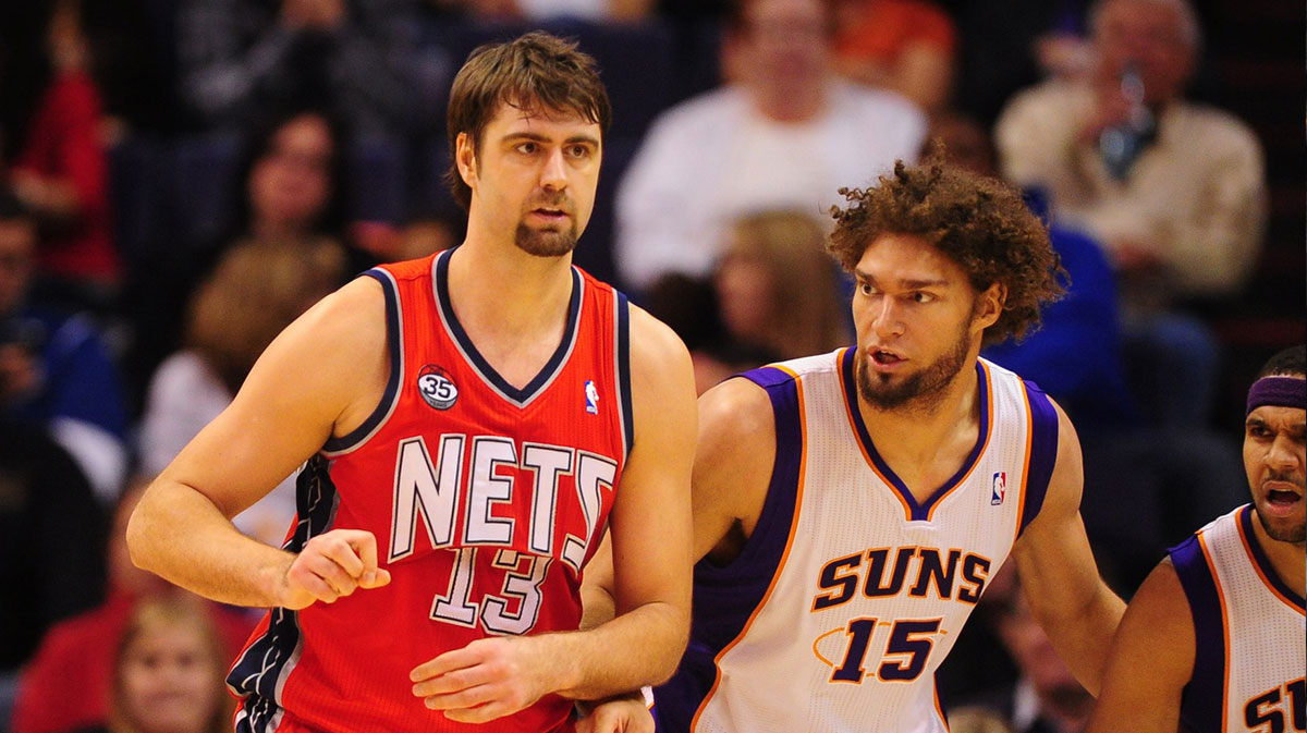 New Jersey Nets center Mehmet Okur (left) and Phoenix Suns center Robin Lopez at the US Airways Center. The Nets defeated the Suns 110-103.