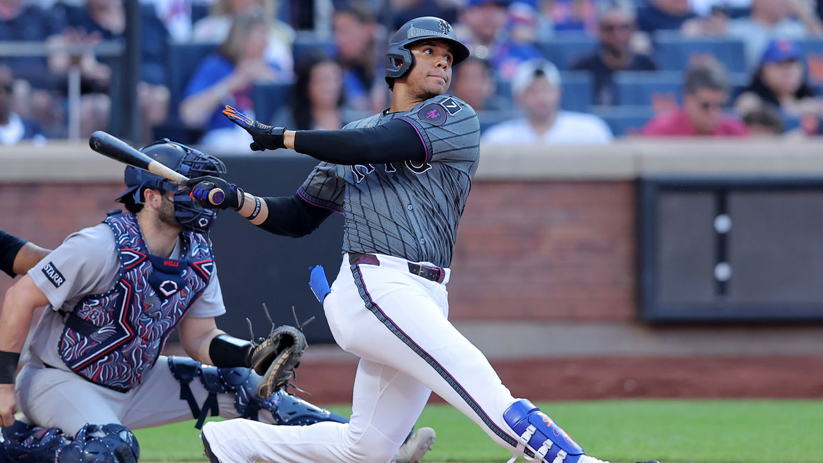 New York Mets right fielder Juan Soto (22) follows through on an RBI single against the New York Yankees during the eighth inning at Citi Field.