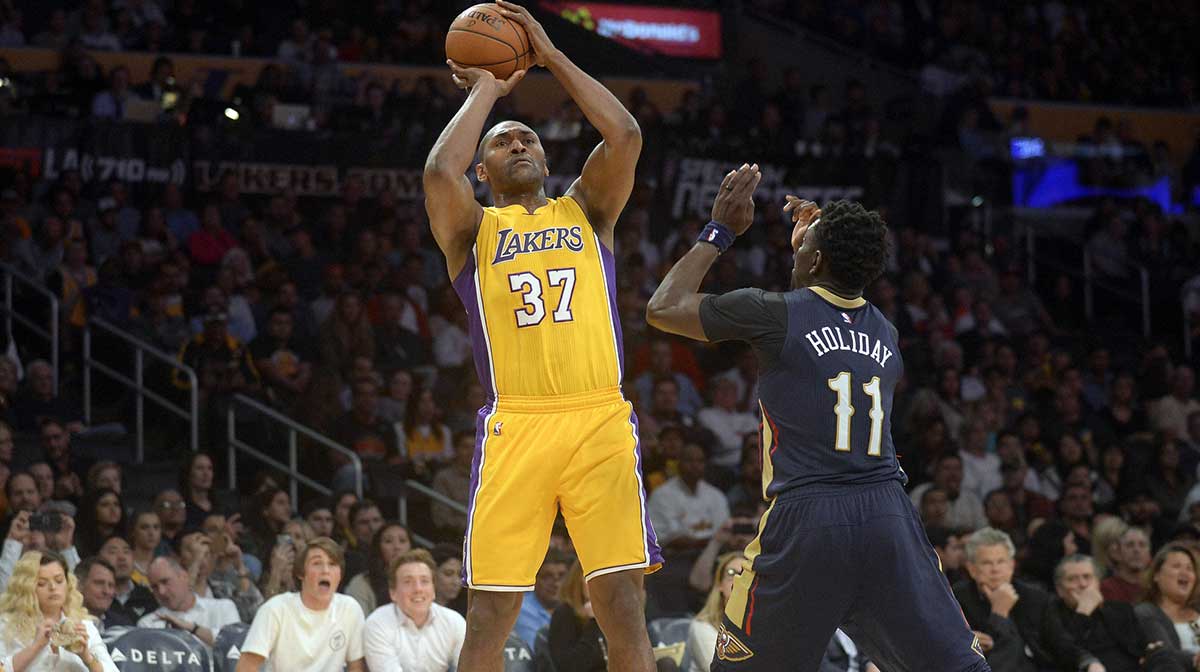 Los Angeles Lakers forward Metta World Peace (37) shoots against New Orleans Pelicans guard Jrue Holiday (11) during the second half at Staples Center.