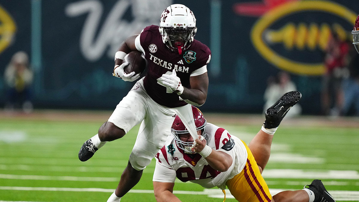 Texas A&M Aggies wide receiver Micah Tease (4) carries the ball against Southern California Trojans defensive tackle Kobe Pepe (94) in the second half at Allegiant Stadium.