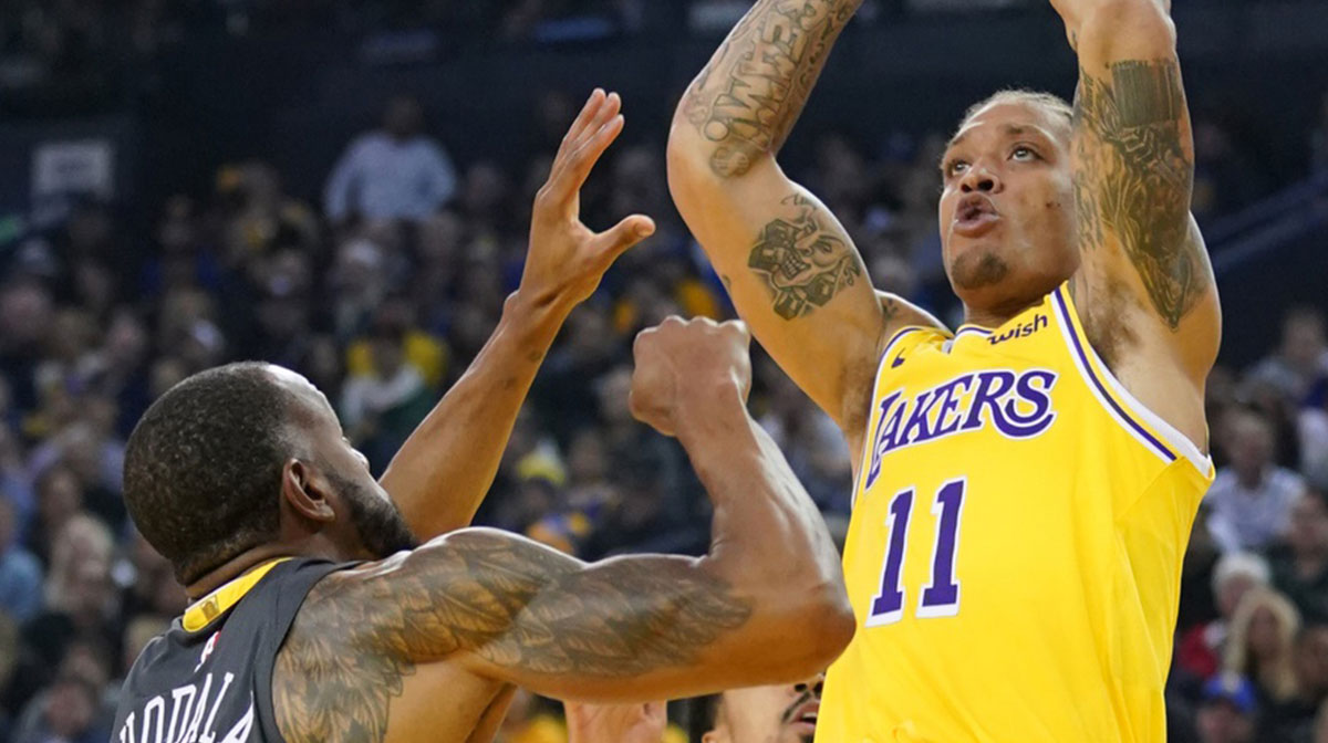 Los Angeles Lakers forward Michael Beasley (11) shoots the basketball against Golden State Warriors forward Andre Iguodala (9) during the second quarter at Oracle Arena.