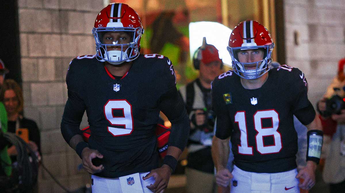 Atlanta Falcons quarterback Michael Penix Jr. (9) and quarterback Kirk Cousins (18) run on the field before a game against the New York Giants at Mercedes-Benz Stadium.