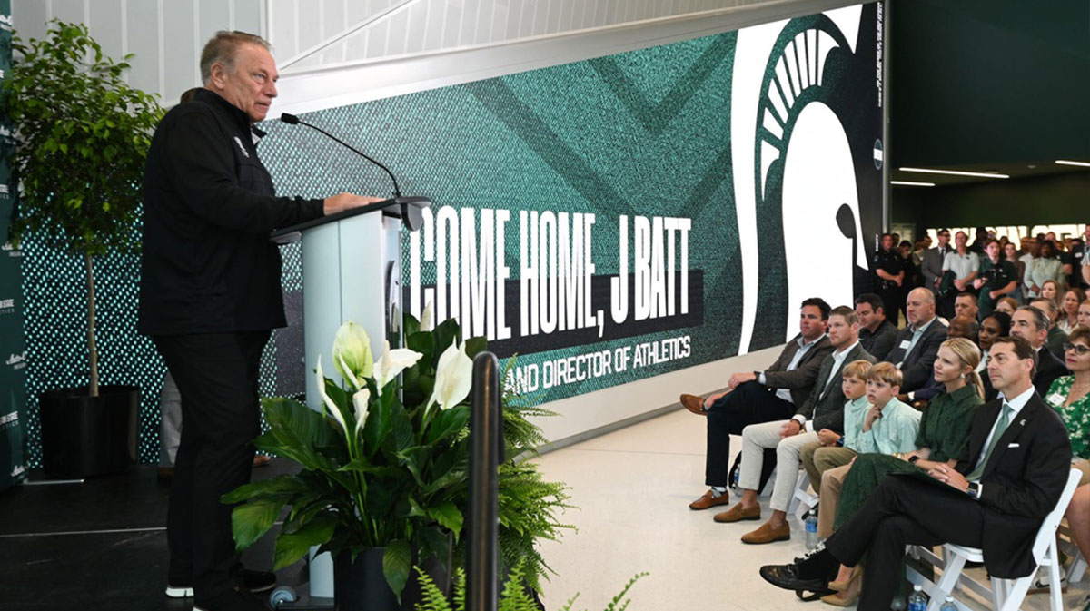 Michigan State University basketball coach Tom Izzo speaks before MSU President Kevin Guskiewicz introduced J Batt (bottom right) as the Spartan’s new athletic director.