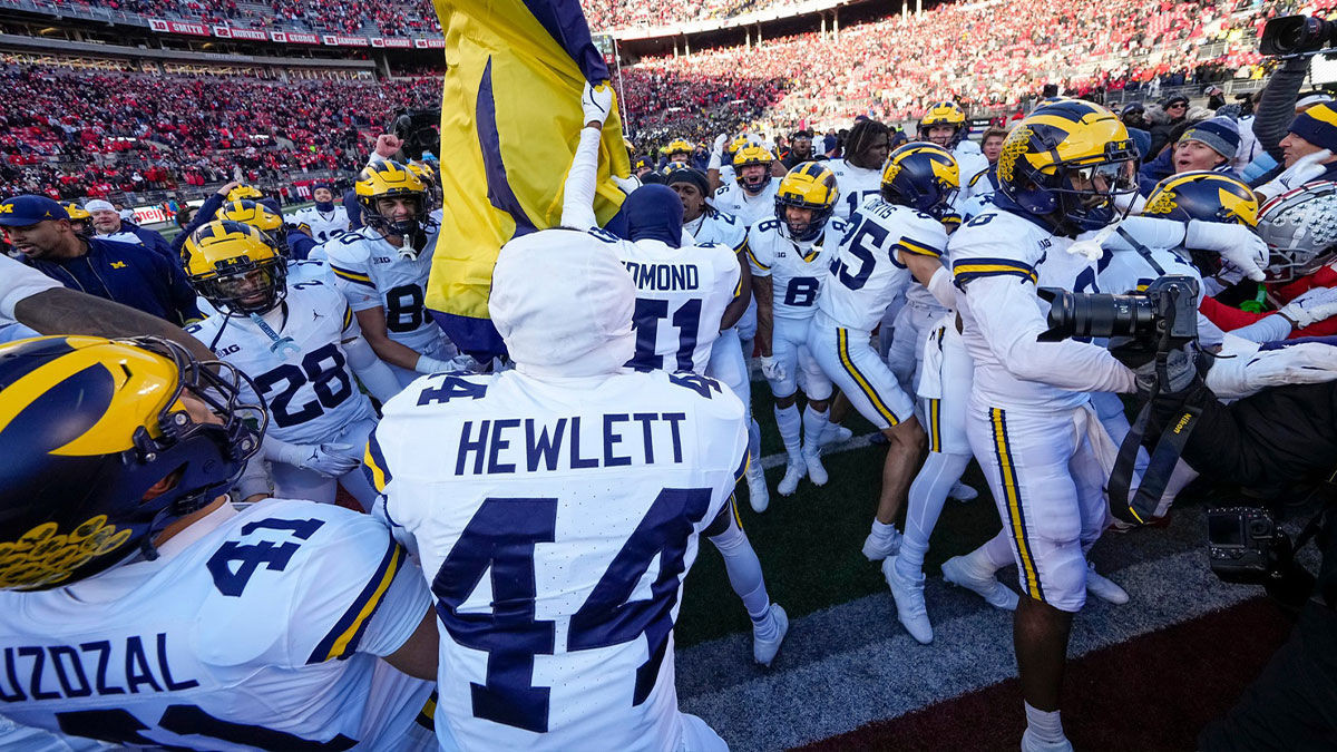 Michigan Wolverines plant a flag on the block-O at midfield following the NCAA football game against the Ohio State Buckeyes at Ohio Stadium
