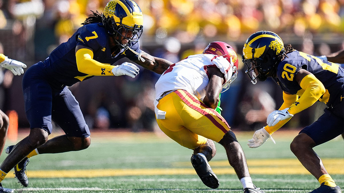 Michigan defensive back Makari Paige (7), left, and defensive back Jyaire Hill (20) tackle USC wide receiver Zachariah Branch (1) during the first half at Michigan Stadium in Ann Arbor on Saturday, Sept. 21, 2024.