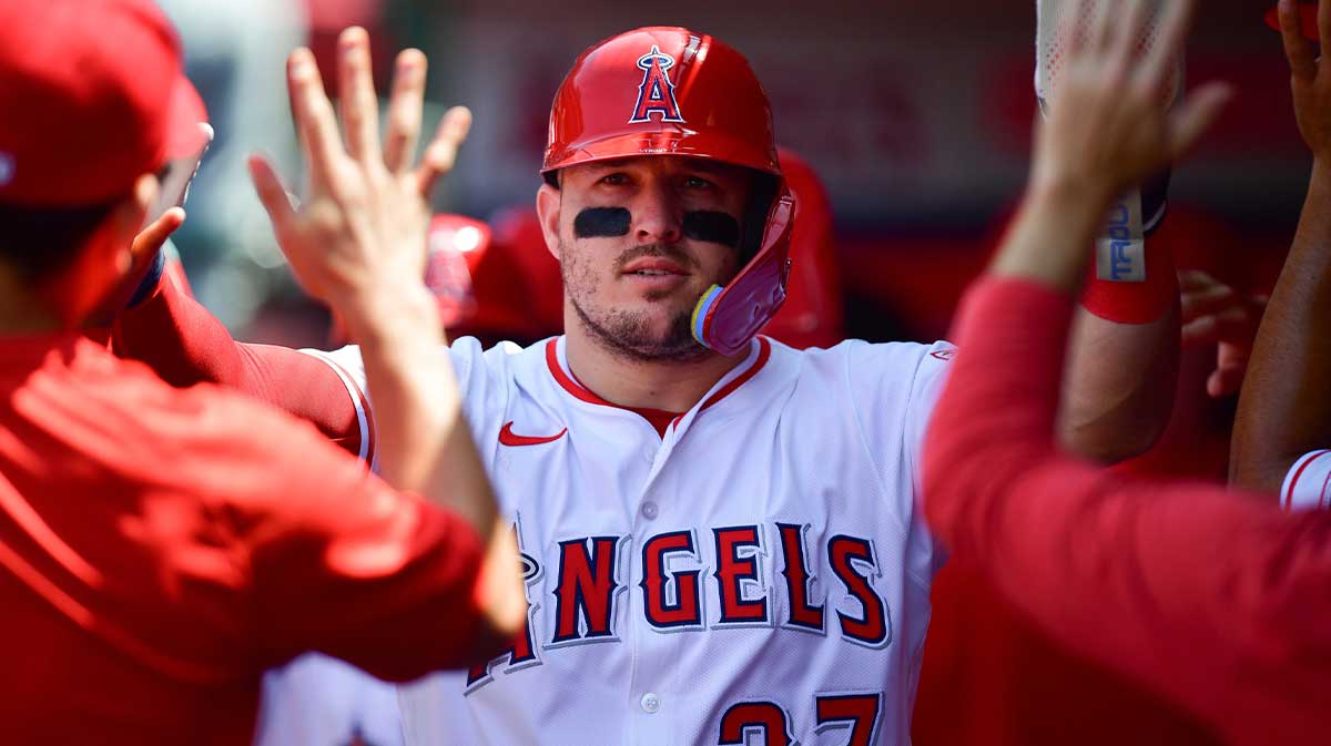 Jun 11, 2025; Anaheim, California, USA; Los Angeles Angels designated hitter Mike Trout (27) is greeted after scoring a run against the Athletics during the sixth inning at Angel Stadium. Mandatory Credit: Gary A. Vasquez-Imagn Images