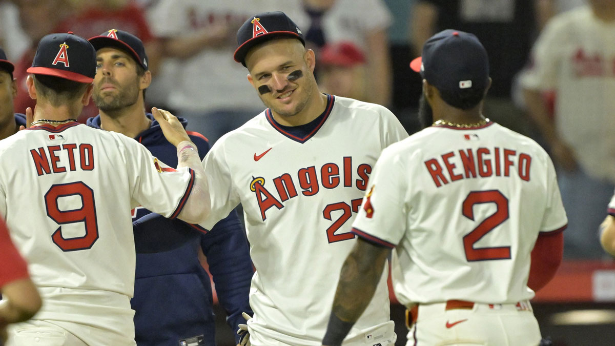 Los Angeles Angels designated hitter Mike Trout (27) congratulates shortstop Zach Neto (9) and third baseman Luis Rengifo (2) after the final out of the ninth inning against the Arizona Diamondbacks at Angel Stadium.