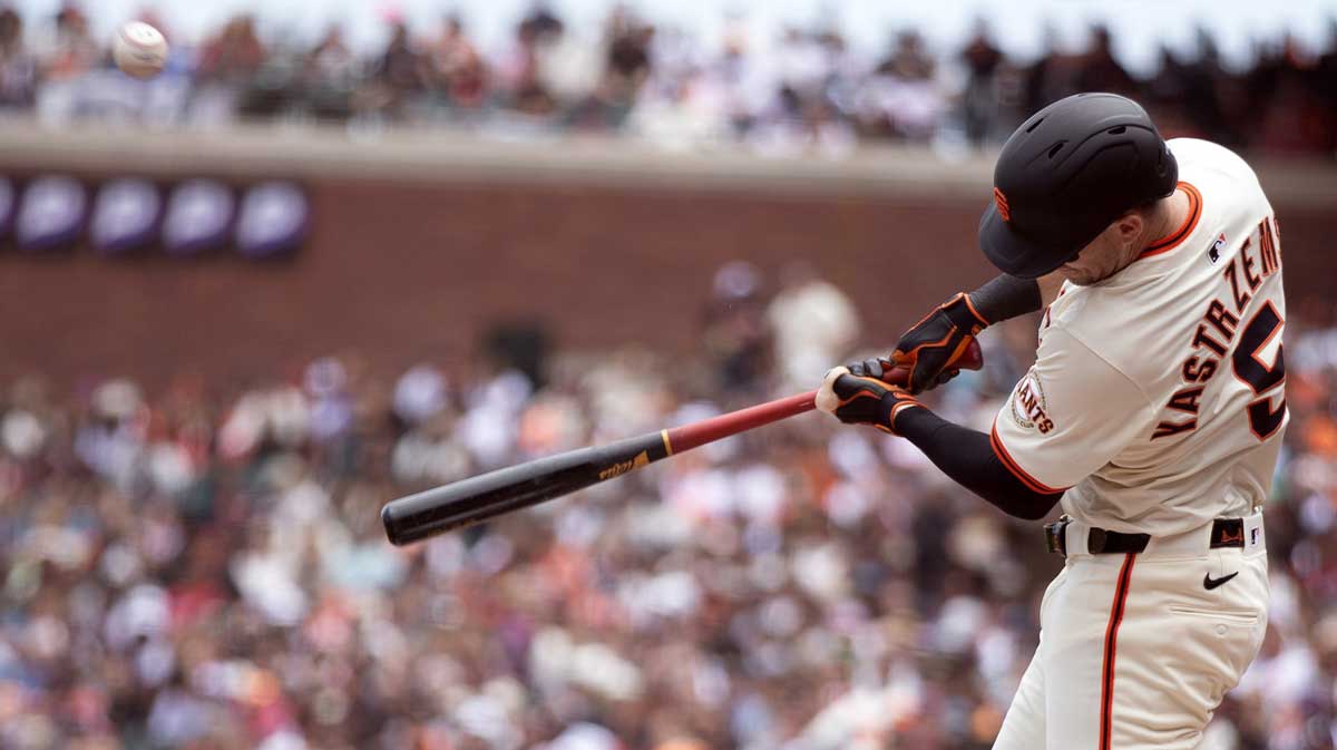 Jun 8, 2025; San Francisco, California, USA; San Francisco Giants right fielder Mike Yastrzemski (5) connects for a sacrifice fly against the Atlanta Braves during the second inning at Oracle Park.