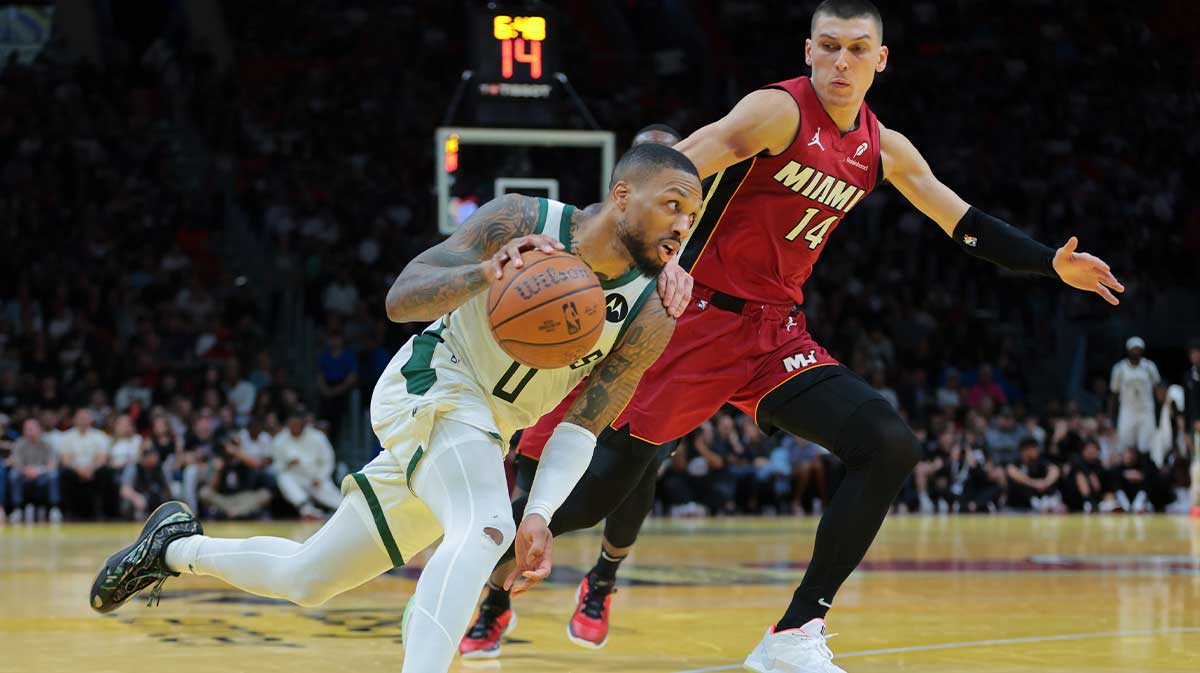 Milwaukee Bucks guard Damian Lillard (0) drives to the basket against Miami Heat guard Tyler Herro (14) during the fourth quarter at Kaseya Center.