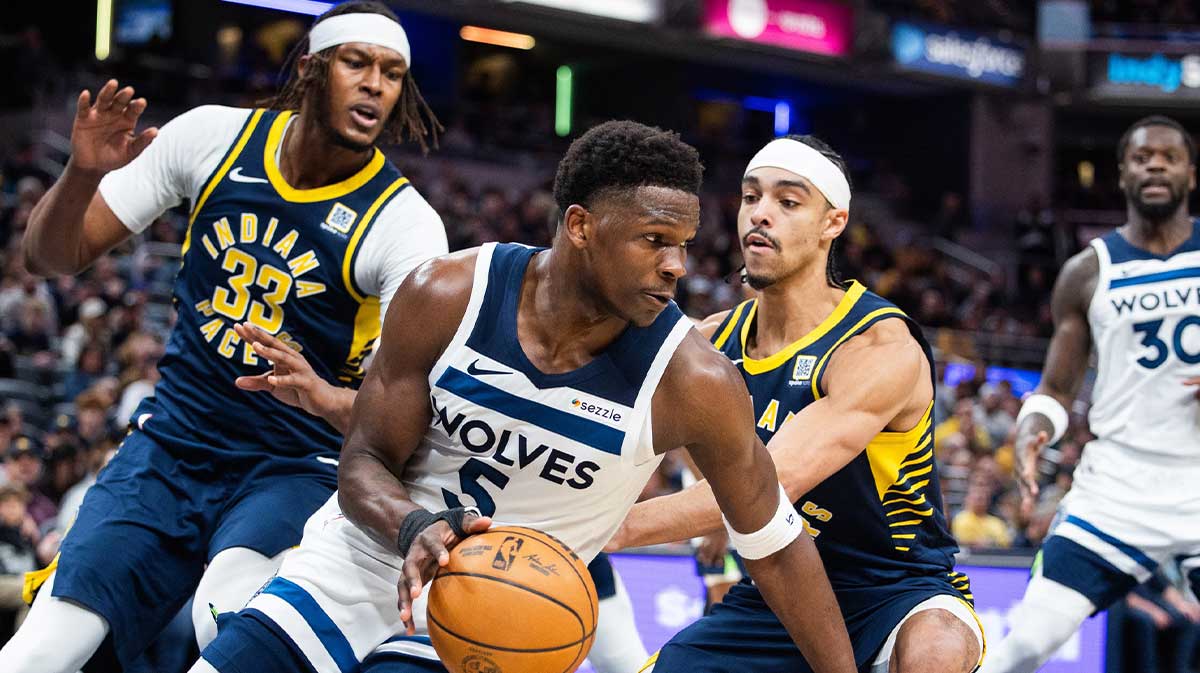 The Minnesota Timberwolves goalkeeper, Anthony Edwards (5), dribble the ball while the Indiana Pacers Center Myles Turner (33) and goalkeeper Andrew Nembhard (2) defend themselves first half at Gainbridge Fieldhouse.