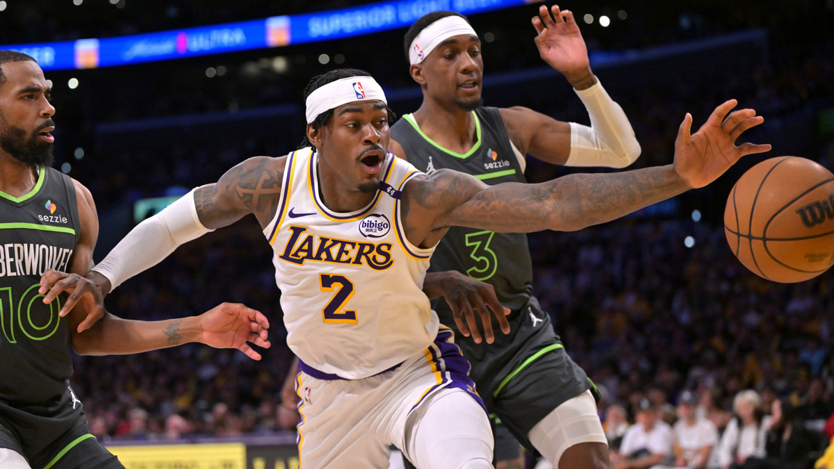 Minnesota Timberwolves guard Mike Conley (10) and forward Jaden McDaniels (3) and Los Angeles Lakers forward Jarred Vanderbilt (2) reach for a loose ball in the first half at Crypto.com Arena. Mandatory Credit: Jayne Kamin-Oncea-Imagn Images