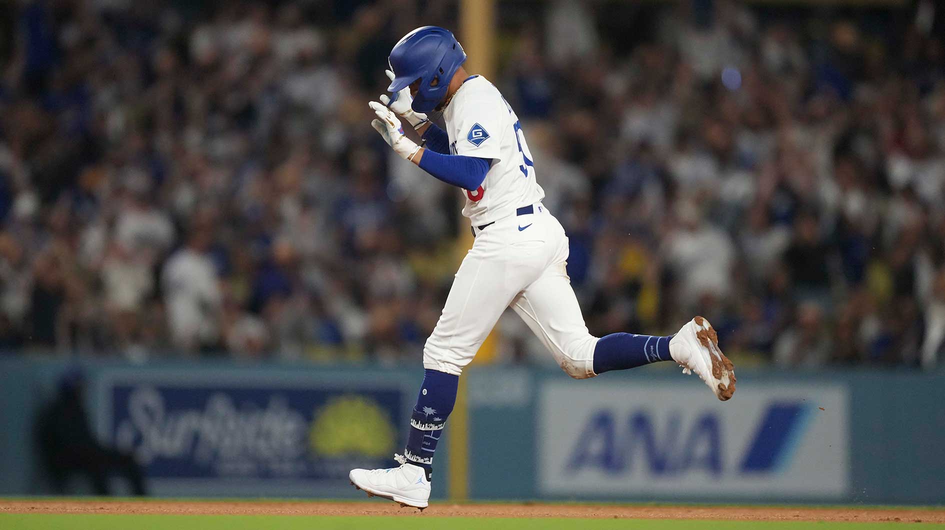 Los Angeles Dodgers shortstop Mookie Betts (50) homers to left center field in the seventh inning at Dodger Stadium.