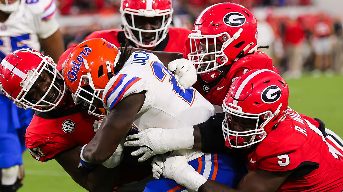 Georgia Bulldogs defensive lineman Mykel Williams (13) wraps up Florida Gators running back Ja'Kobi Jackson (24) during the second half at EverBank Stadium in Jacksonville, FL on Saturday, November 2, 2024. The Bulldogs defeated the Gators 34-20.
